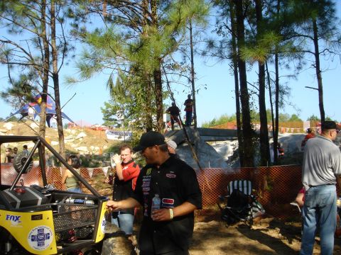 2002 Jeep Wrangler - A group of people gather around a custom-built off-road buggy at an outdoor event.