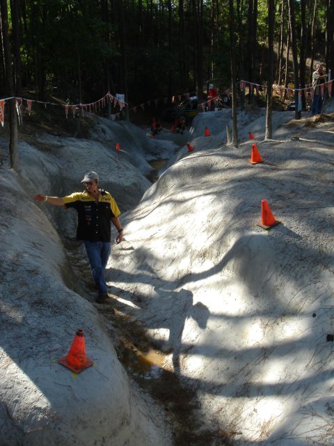 2002 Jeep Wrangler - A man gestures while navigating an off-road course marked with orange cones.
