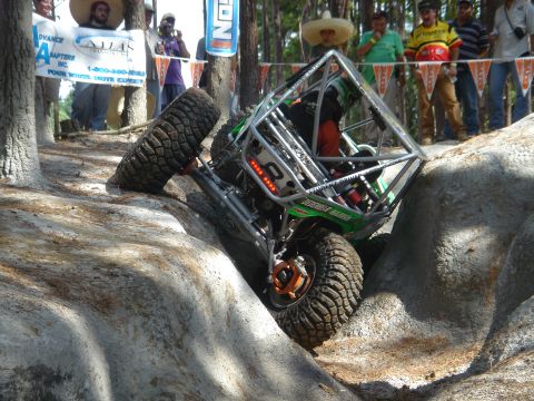 2002 Jeep Wrangler - An off-road buggy attempts to climb a steep, rocky obstacle during an event.