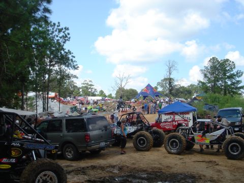 2002 Jeep Wrangler - Multiple off-road vehicles and spectators are present at an outdoor event.