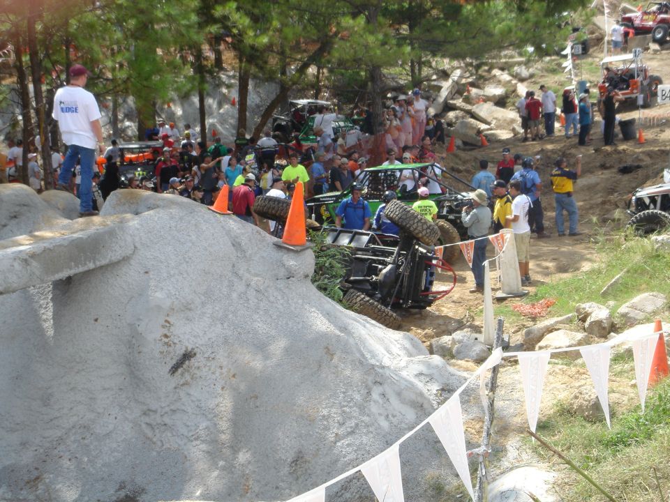 Tube-chassis rock buggy rolled on its side at an off-road rock crawling event