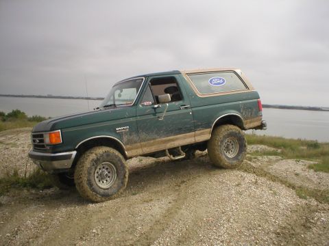 1990 Ford Bronco - This 1990 Ford Bronco is captured in a 3/4 front view as it navigates an off-road trail.