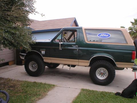 1990 Ford Bronco - Side view of a 1990 Ford Bronco with a Ford logo on the rear window.