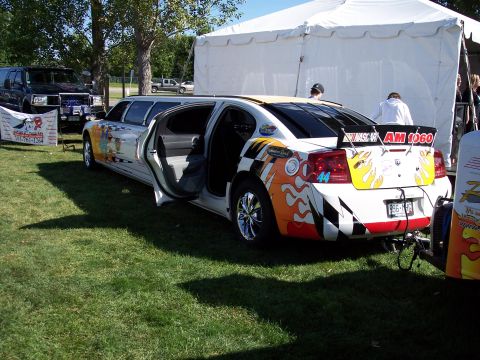 1972 Ford Ranchero - A custom-built limousine, decorated with racing-themed graphics, is parked on a grassy field.