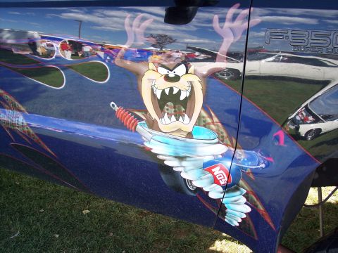 1972 Ford Ranchero - Custom painted truck door features Tazmanian Devil artwork and NOS branding, reflecting other vehicles.