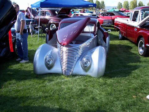 1972 Ford Ranchero - A custom hot rod coupe is displayed at an outdoor car show with other vehicles.