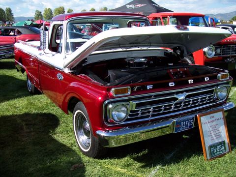 1972 Ford Ranchero - A red and white 1966 Ford pickup truck is displayed with its hood open at an outdoor event.