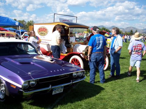 1972 Ford Ranchero - A purple 1970 Dodge Challenger is parked at an outdoor car show next to an antique truck.