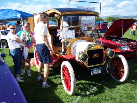 1972 Ford Ranchero - A vintage Ford Model T truck is displayed at an outdoor event with people gathered around.