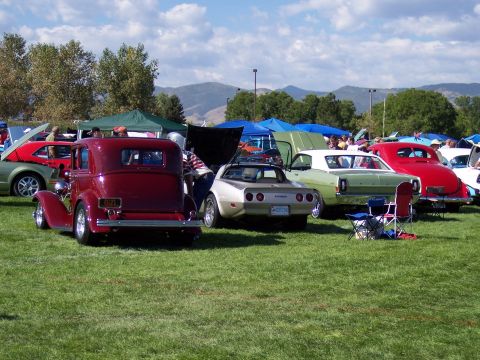 1972 Ford Ranchero - Outdoor car show with multiple vintage vehicles on display under a sunny sky.