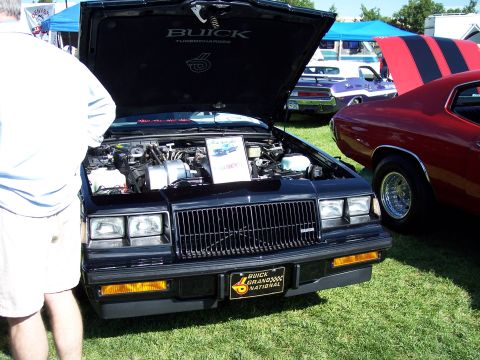 1972 Ford Ranchero - Black 1987 Buick Grand National displayed with hood open at an outdoor car show.