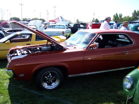 1972 Ford Ranchero - A 1972 Ford Ranchero is displayed at a car show with its hood open, parked on grass among other vehicles.
