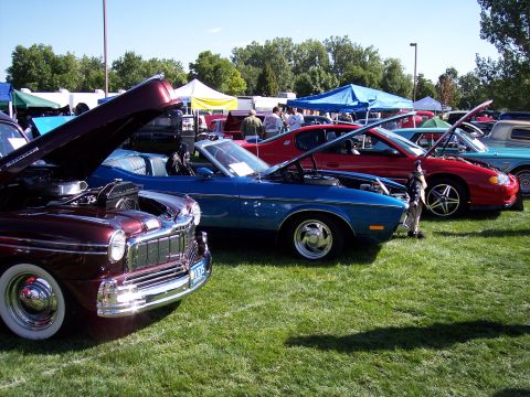 1972 Ford Ranchero - Cars lined up on display at an outdoor car show with tents in the background.
