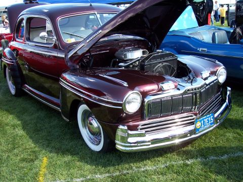 1972 Ford Ranchero - A maroon 1946 Mercury Coupe is displayed with its hood open, revealing the engine compartment.