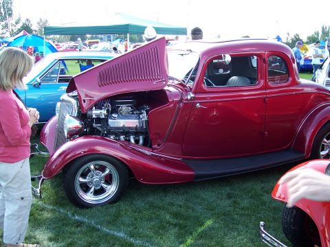 1972 Ford Ranchero - A red 1935 Ford coupe hot rod displays its engine at an outdoor car show event.