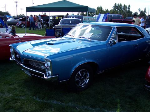 1972 Ford Ranchero - Blue 1967 Pontiac GTO coupe displayed at an outdoor car show event.