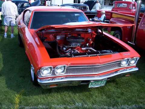 1972 Ford Ranchero - This orange 1969 Chevrolet Chevelle SS coupe is displayed with its hood open, revealing the engine and a custom license plate.