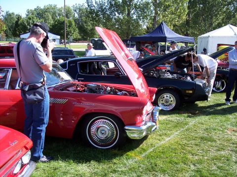 1972 Ford Ranchero - A red 1957 Ford Thunderbird is displayed with its hood open at an outdoor car show.