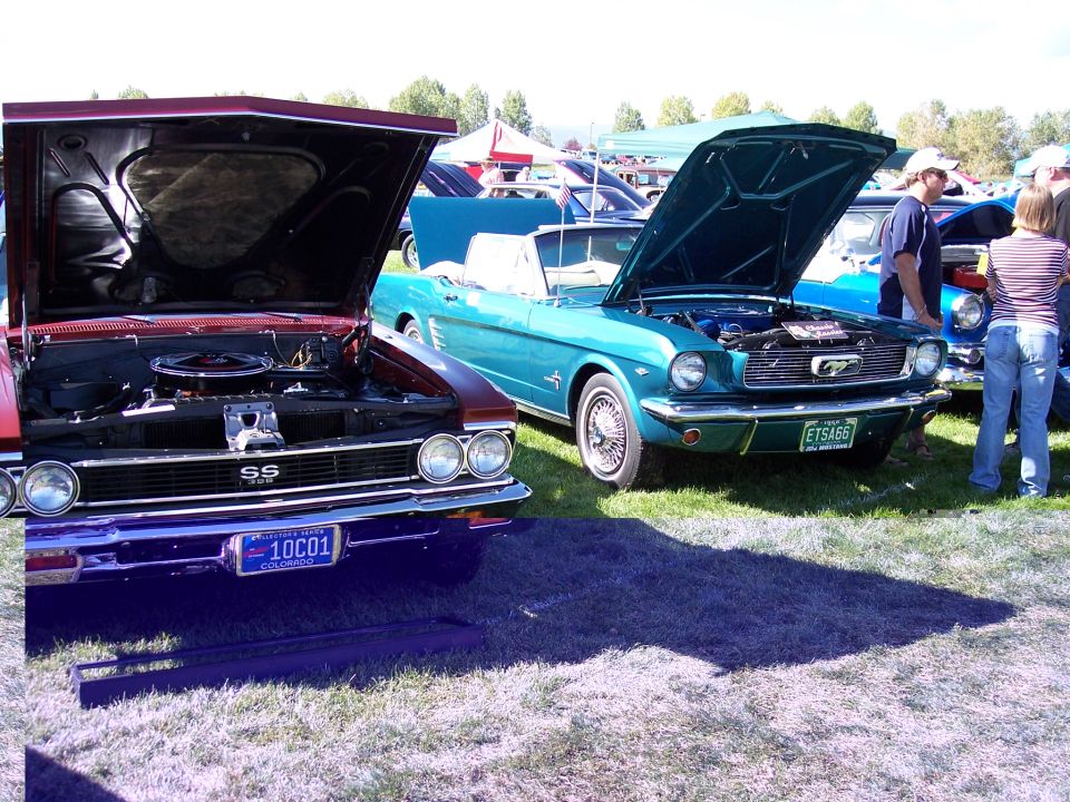 Red car with SS badge and blue license plate, next to a teal convertible with a Mustang emblem and green license plate