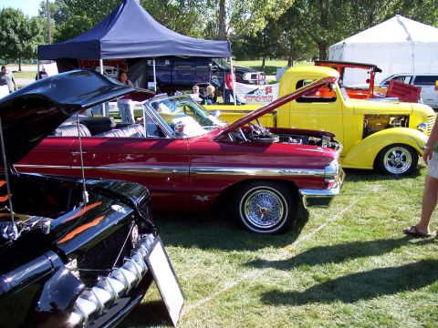 1972 Ford Ranchero - Two classic vehicles are displayed on a grassy field under tents at an outdoor event.