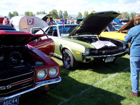 1972 Ford Ranchero - A green AMC Javelin is displayed with its hood open at an outdoor car show.