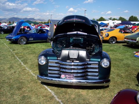 1972 Ford Ranchero - A dark green 1947 Chevrolet truck is displayed with its hood open at an outdoor car show.
