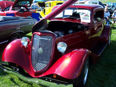 1972 Ford Ranchero - A custom hot rod is displayed with its hood open, revealing the engine bay.