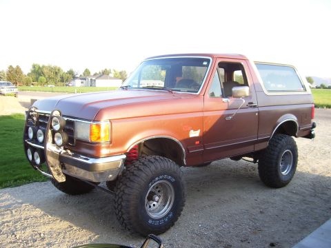 1990 Ford Bronco - This lifted 1990 Ford Bronco features a prominent bull bar and off-road tires.