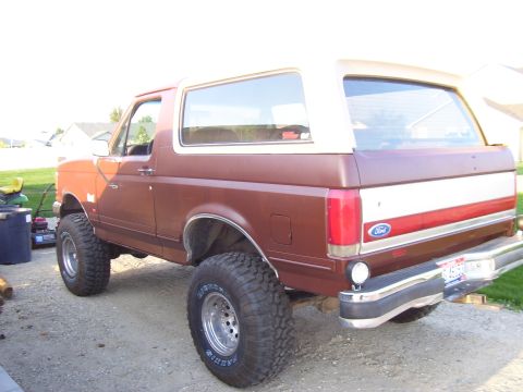 1990 Ford Bronco - Rear view of a lifted 1990 Ford Bronco with aftermarket wheels and tires.