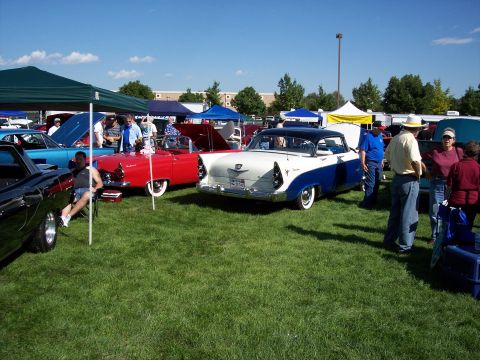 1972 Ford Ranchero - A white and blue classic car is parked on the grass at an outdoor event with people milling around.
