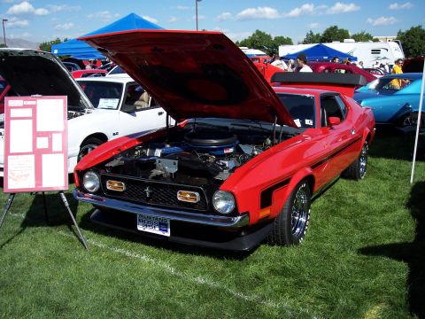 1972 Ford Ranchero - A red 1971 Ford Mustang Boss 351 is displayed with its hood open at an outdoor car show.