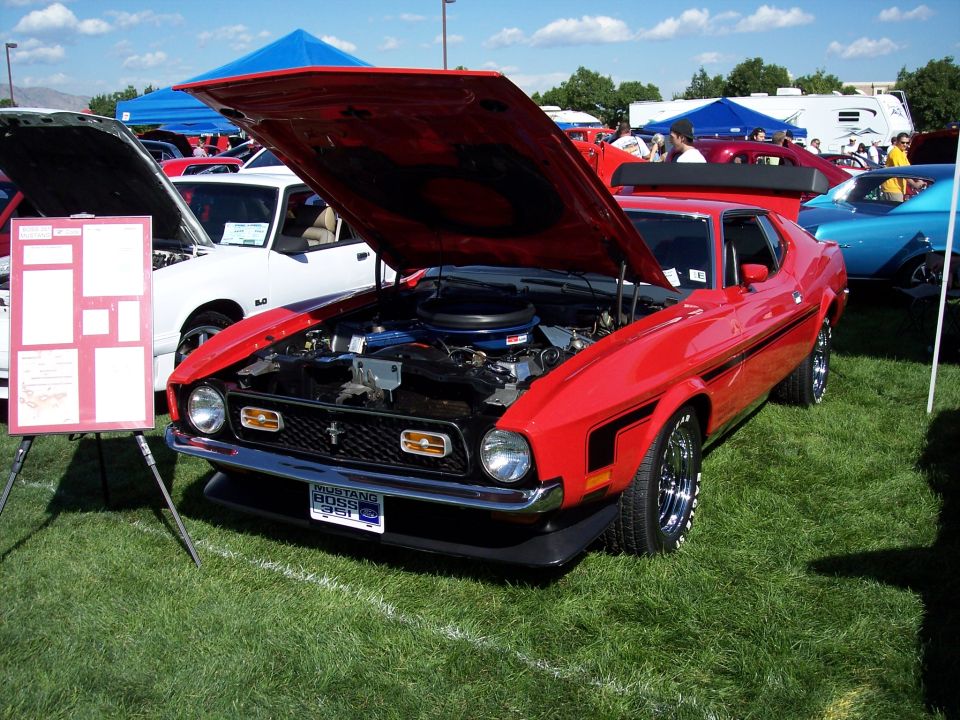 Red 1971 Ford Mustang Boss 351 with hood open, showing engine