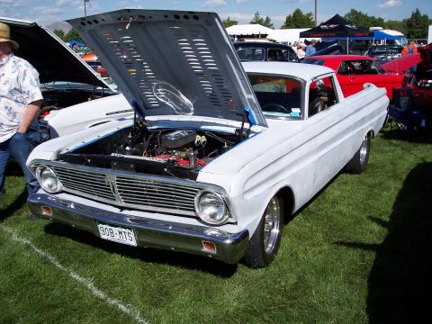 1972 Ford Ranchero - A white pickup truck is displayed with its hood open at an outdoor event.