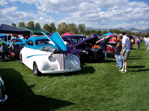 1972 Ford Ranchero - Several vintage cars are displayed on a grassy field under a partly cloudy sky at an outdoor event.