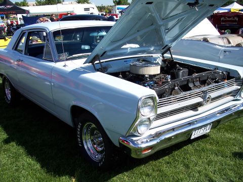 1972 Ford Ranchero - A light blue 1967 Ford Fairlane 500 is displayed with its hood open at an outdoor car show.