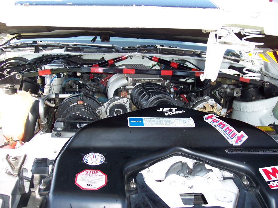 Engine bay showing aftermarket intake, strut bar, and various stickers including 'JET Powered' and 'Summit Racing Equipment'