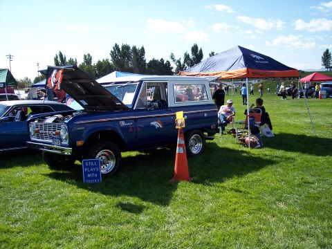1972 Ford Ranchero - A blue Ford Bronco is displayed at an outdoor event with its hood up.