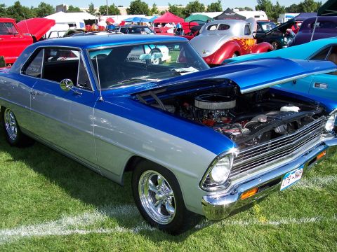 1972 Ford Ranchero - A classic two-tone coupe is displayed at an outdoor car show with its hood open.