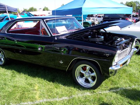 1972 Ford Ranchero - A black 1967 Chevrolet Nova coupe is displayed with its hood open at an outdoor car show.
