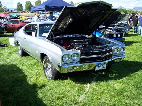 1972 Ford Ranchero - A silver 1970 Chevrolet Chevelle SS is displayed with its hood open at an outdoor car show.