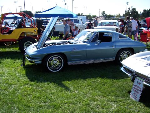 1972 Ford Ranchero - A light blue 1963 Corvette Sting Ray coupe is displayed at an outdoor car show with its hood open.