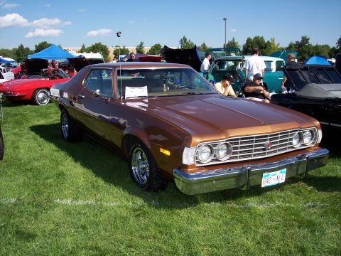 1972 Ford Ranchero - A brown 1972 Ford Ranchero is displayed on a grassy field at an outdoor car show.