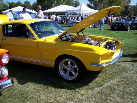 1972 Ford Ranchero - This yellow 1967 Ford Mustang GT500 has its hood open, revealing a custom engine and chrome wheels.