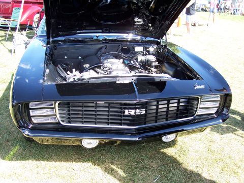 1972 Ford Ranchero - Black 1969 Chevrolet Camaro RS front end with hood open, engine visible.
