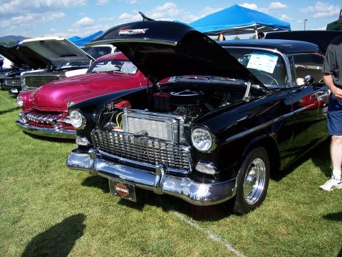 1972 Ford Ranchero - A row of classic cars are displayed on a grassy field under a bright blue sky.