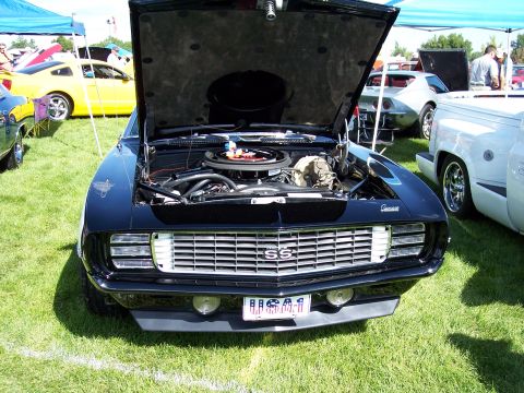 1972 Ford Ranchero - Front view of a black 1969 Camaro SS at a car show, engine exposed.