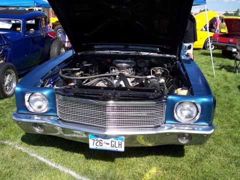 1972 Ford Ranchero - A blue 1970 Chevrolet Chevelle is displayed with its hood open, revealing the engine and chrome grille.