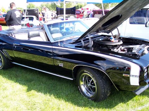1972 Ford Ranchero - A black 1969 Chevrolet Camaro SS convertible is displayed with its hood open at an outdoor car show.