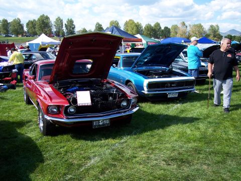1972 Ford Ranchero - A red 1969 Ford Mustang Mach 1 is displayed with its hood open at an outdoor car show.