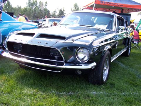 1972 Ford Ranchero - A classic dark green 1967 Ford Mustang Shelby GT500 is displayed at an outdoor car show.